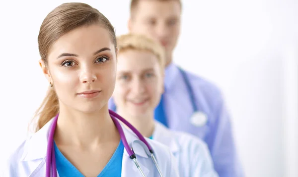 Attractive female doctor in front of medical group — Stock Photo, Image