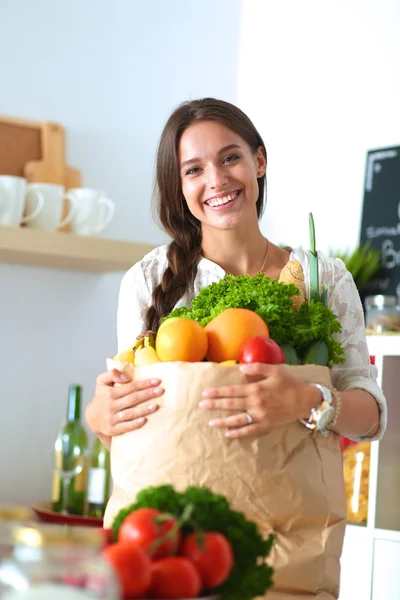 Fiatal nő gazdaság élelmiszerbolt bevásárló táska zöldségekkel — Stock Fotó