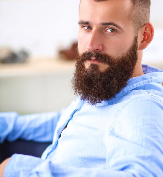 Young businessman sitting on chair in office — Stock Photo, Image