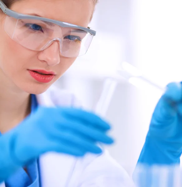 Woman researcher is surrounded by medical vials and flasks, isolated on white background — Stock Photo, Image