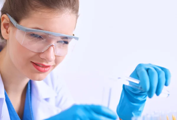 Woman researcher is surrounded by medical vials and flasks, isolated on white background — Stock Photo, Image