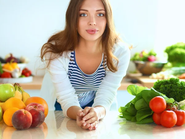 Young woman sitting near desk in the kitchen — Stock Photo, Image