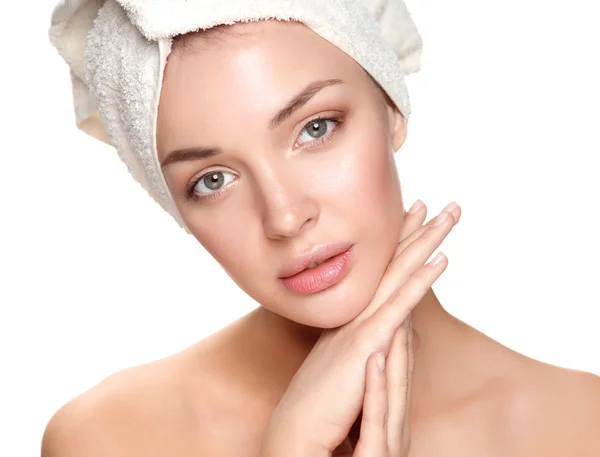 Portrait of beautiful girl touching her face with a towel on  head — Stock Photo, Image