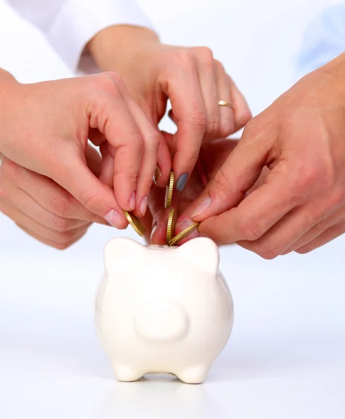 Putting coin into the piggy bank — Stock Photo, Image