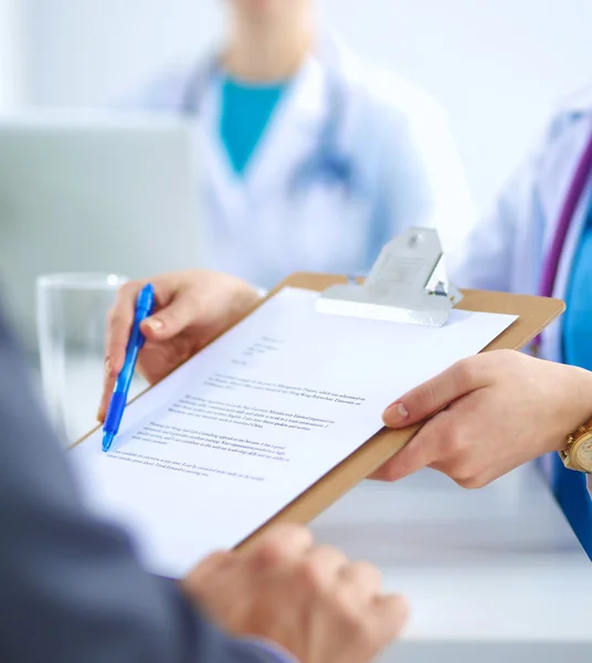 Medical team sitting at the table in modern hospital — Stock Photo, Image