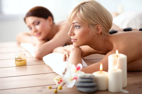 Dos mujeres hermosas jóvenes relajándose y disfrutando en el centro de spa — Foto de Stock