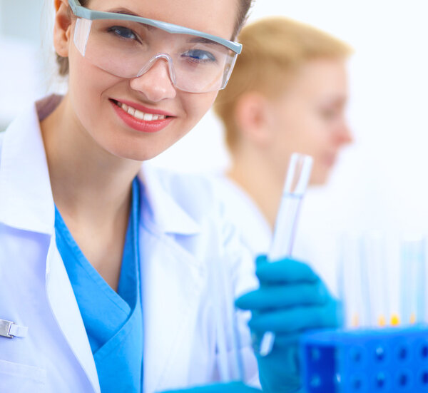 Woman researcher is surrounded by medical vials and flasks, isolated on white background