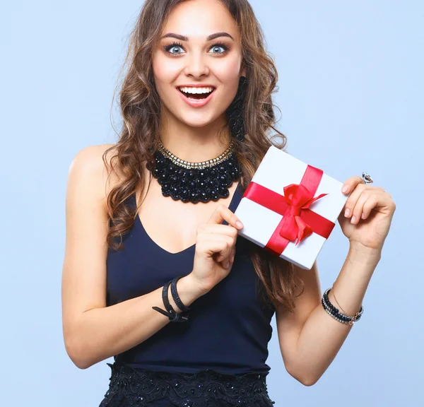 Young woman happy smile hold gift box in hands, isolated over gray background — Stock Photo, Image