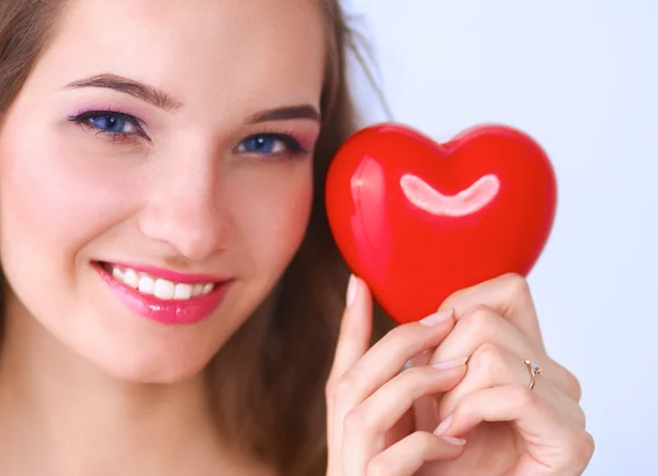 Portrait of beautiful happy woman holding a symbol heart. — Stock Photo, Image