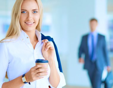 Yound kadın ayakta ofisindeki kahve içmek