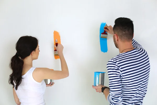 Portrait of happy smiling young couple  painting interior wall of new house — Stock Photo, Image