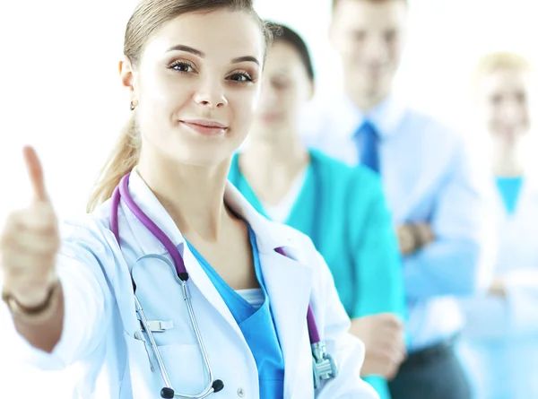 Attractive female doctor in front of medical group — Stock Photo, Image