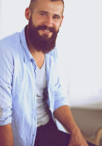 Young businessman sitting on chair in office — Stock Photo, Image