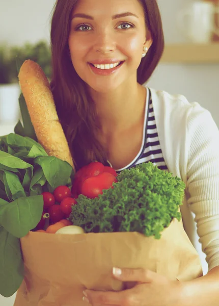 Junge Frau hält Einkaufstüte mit Gemüse — Stockfoto