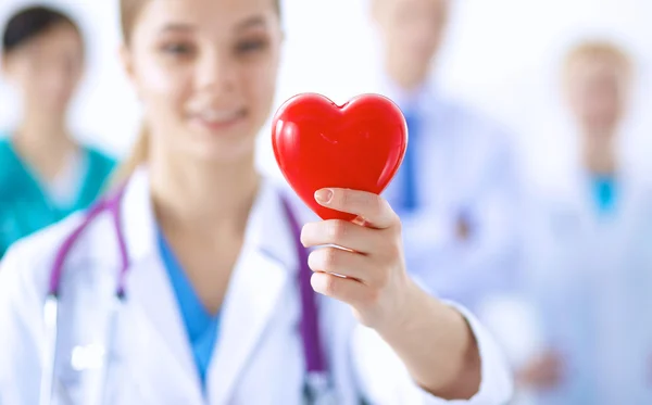 Female doctor with stethoscope holding heart — Stock Photo, Image