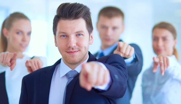 Group of business people pointing to you