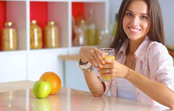 Young woman sitting a table  in the kitchen — Stock Photo, Image