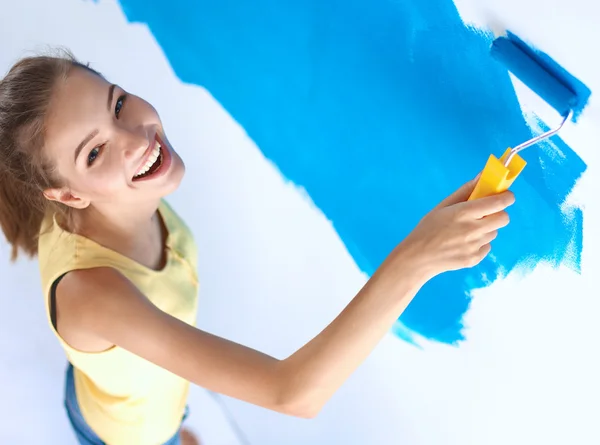 Beautiful young woman doing wall painting — Stock Photo, Image