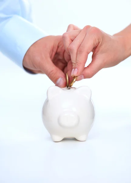 People putting coin into the piggy bank — Stock Photo, Image