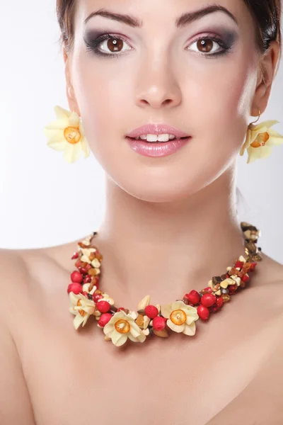 Portrait of young woman with beads, isolated on white background Stock Picture