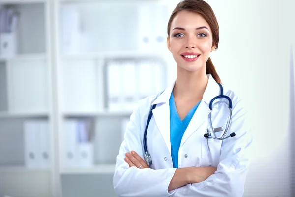 Portrait of young woman doctor with white coat standing in hospital — Stock Photo, Image