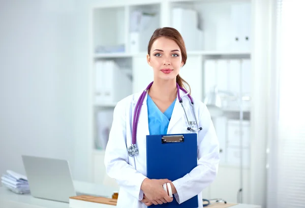 Portrait of young woman doctor with white coat standing in hospital — Stock Photo, Image