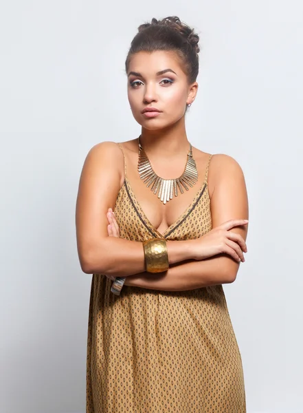 Young woman wearing a beige dress standing — Stock Photo, Image