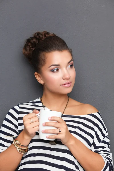 Portrait of young woman with cup tea or coffee — Stock Photo, Image