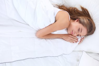 Güzel bir kadın yatağında uzanıyor.
