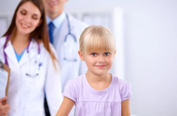 Female doctor examining child with stethoscope at surgery — Stock Photo, Image