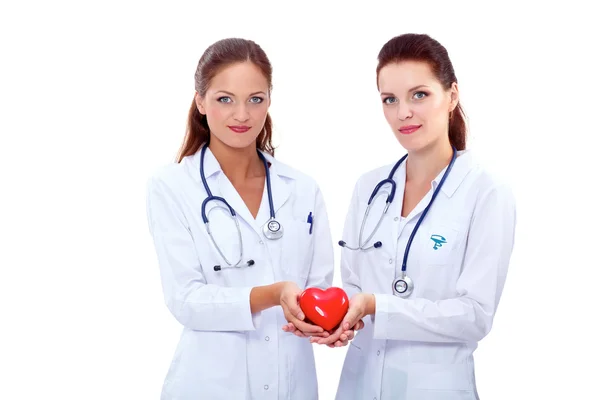 Two woman doctor holding a red heart — Stock Photo, Image