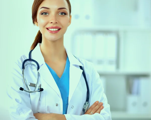 Portrait of young woman doctor with white coat standing in hospital — Stock Photo, Image