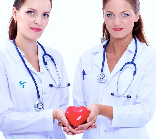 Two woman doctor holding a red heart — Stock Photo, Image