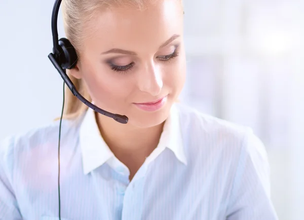 Close-up portrait of a customer service agent sitting at office — Stock Photo, Image