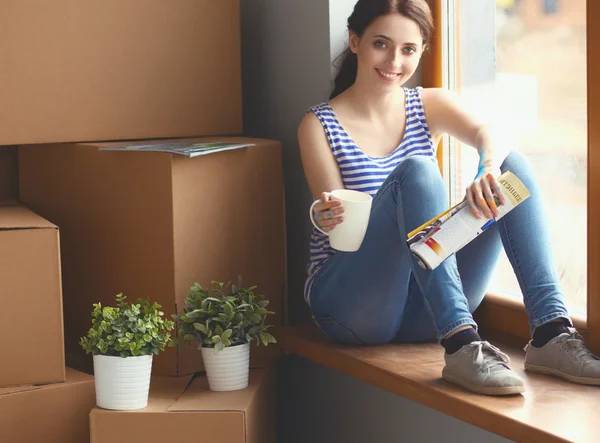 Girl sitting on windowsill at new home — Stock Photo, Image