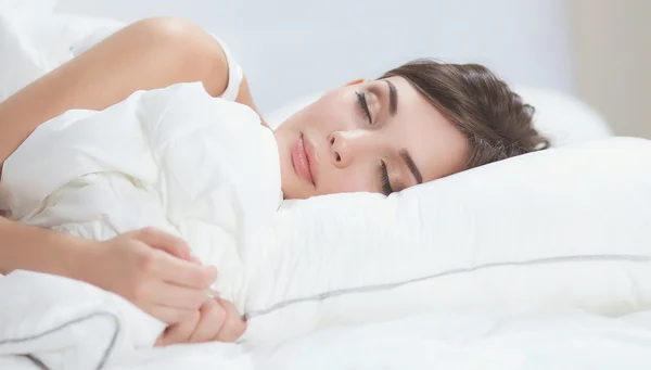 Beautiful girl sleeps in the bedroom, lying on bed — Stock Photo, Image