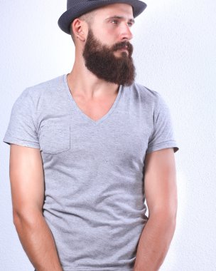 kötü ile duran şapkalı yakışıklı sakallı adam portresi izole beyaz zemin üzerine