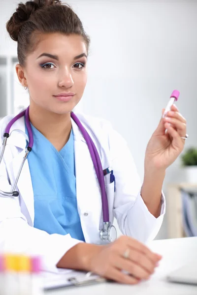 Woman researcher is surrounded by medical vials and flasks, isolated on white background — Stock Photo, Image