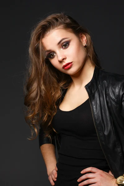 Portrait of beautiful brunette female wearing leather jacket — Stock Photo, Image