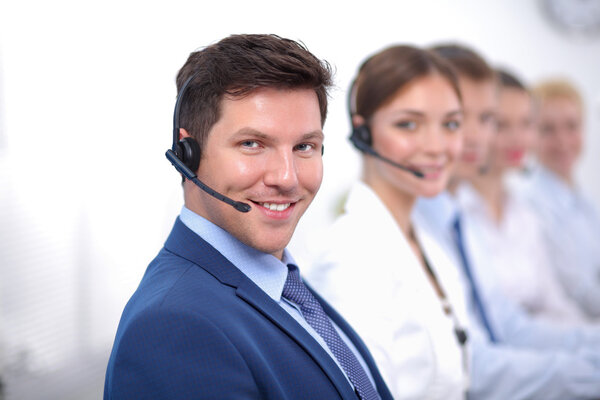 Smiling positive young businesspeople and colleagues in a call center office