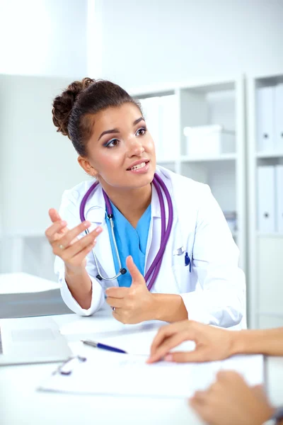 Doctor and patient sitting on the desk at office — Stock Photo, Image