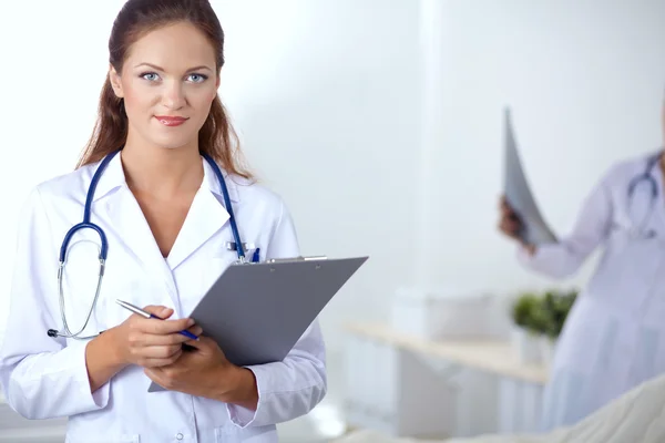 Woman doctor standing at hospital Stock Photo