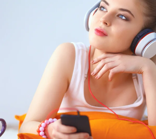 Jeune femme couchée sur le sol et écouter de la musique — Photo