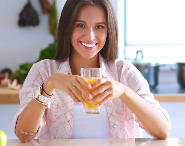 Young woman sitting a table  in the kitchen — Stock Photo, Image