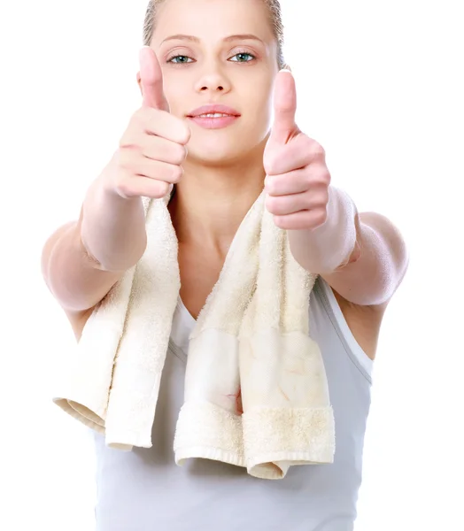 Young sportive girl with towel showing ok, isolated on white background — Stock Photo, Image