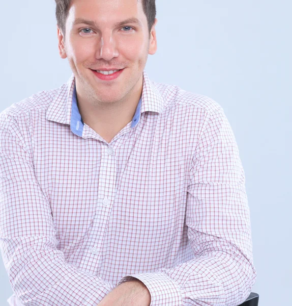 Portrait of a smart young man standing on gray background — Stock Photo, Image