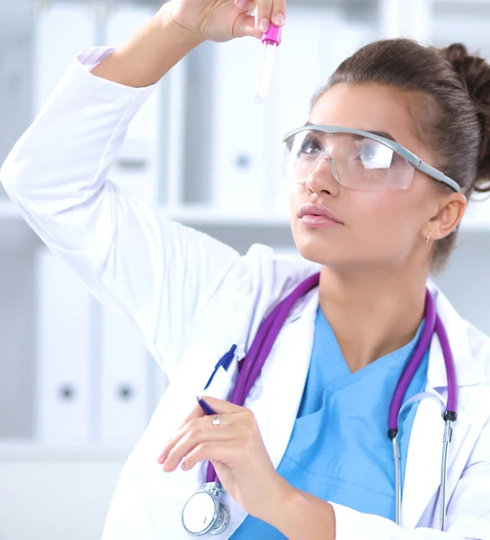 Woman researcher is surrounded by medical vials and flasks — Stock Photo, Image