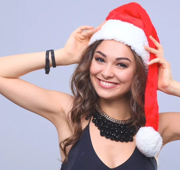 Attractive smiling woman in Santa Cap. Isolated over a gray background. — Stock Photo, Image