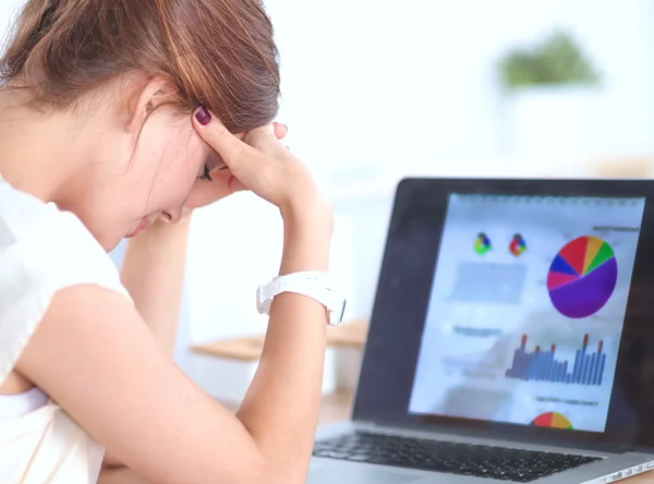 Portrait of tired young business woman with laptop computer at the office — Stock Photo, Image