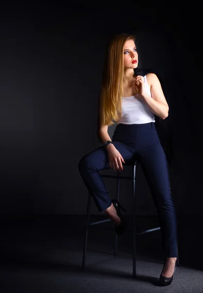 Young woman sitting on a chair — Stock Photo, Image